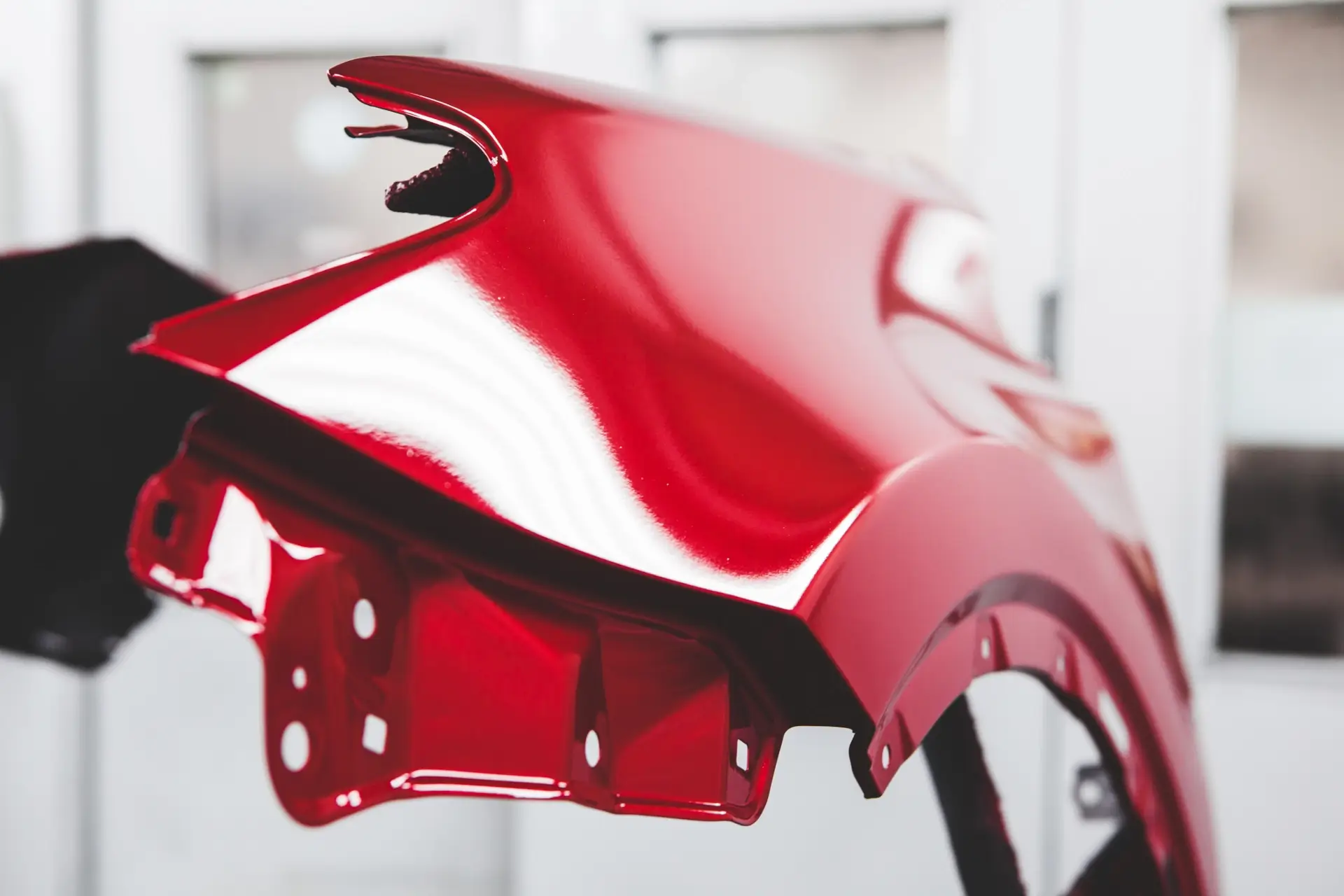 Automobile body panel being painted.