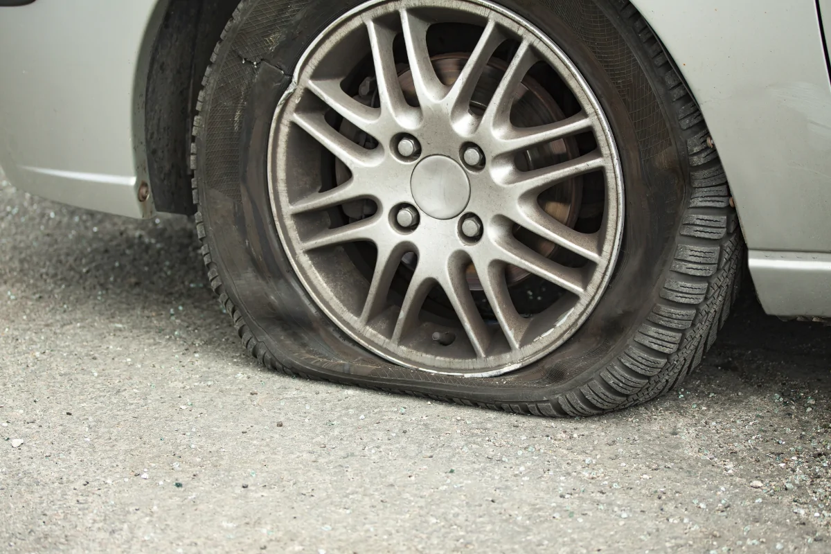Flat tire and damaged wheel after a minor accident